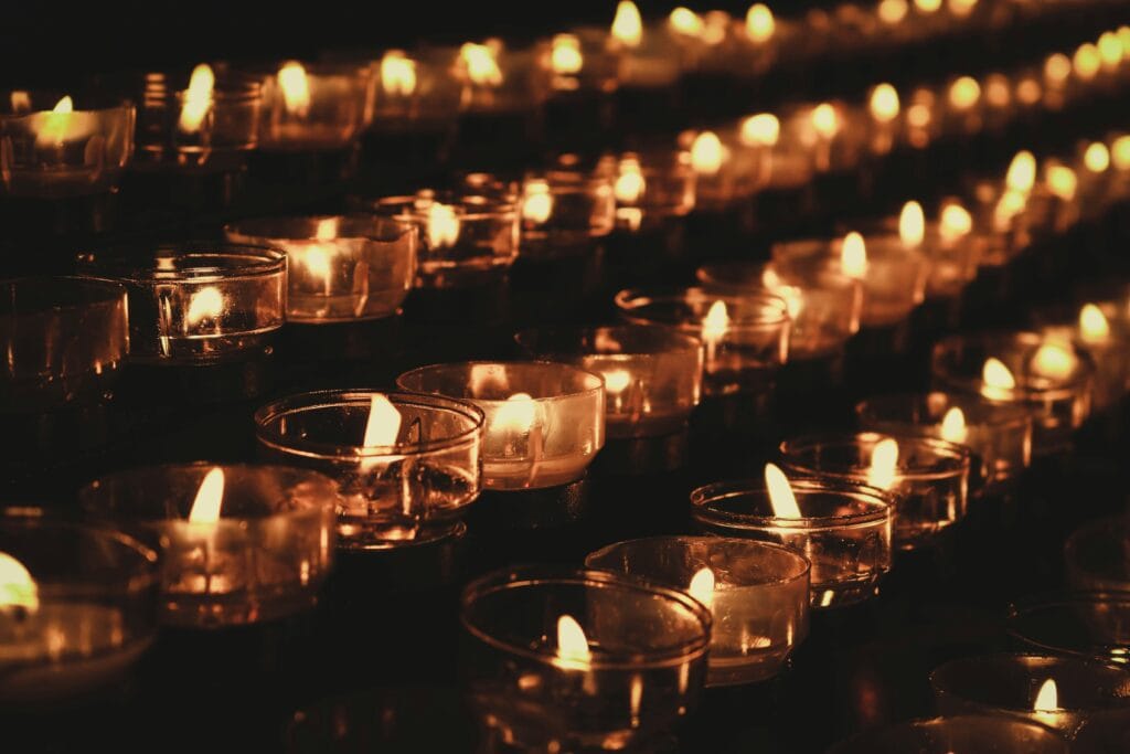 Natural beeswax candles glowing warmly, emitting a soft golden light and a subtle honey fragrance, perfect for a cozy atmosphere.